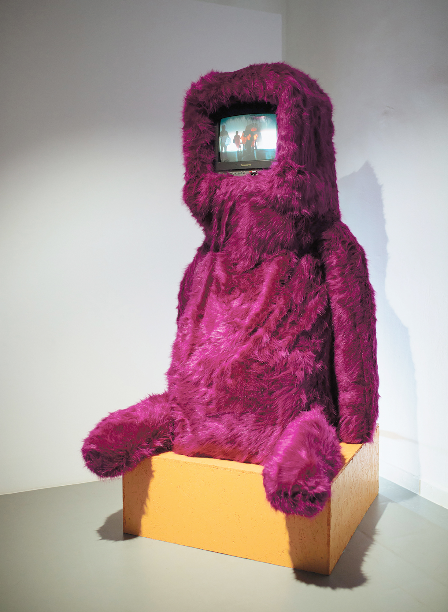 Alt /\ Data [altădată] — furry seated figure with a video screen, installation view